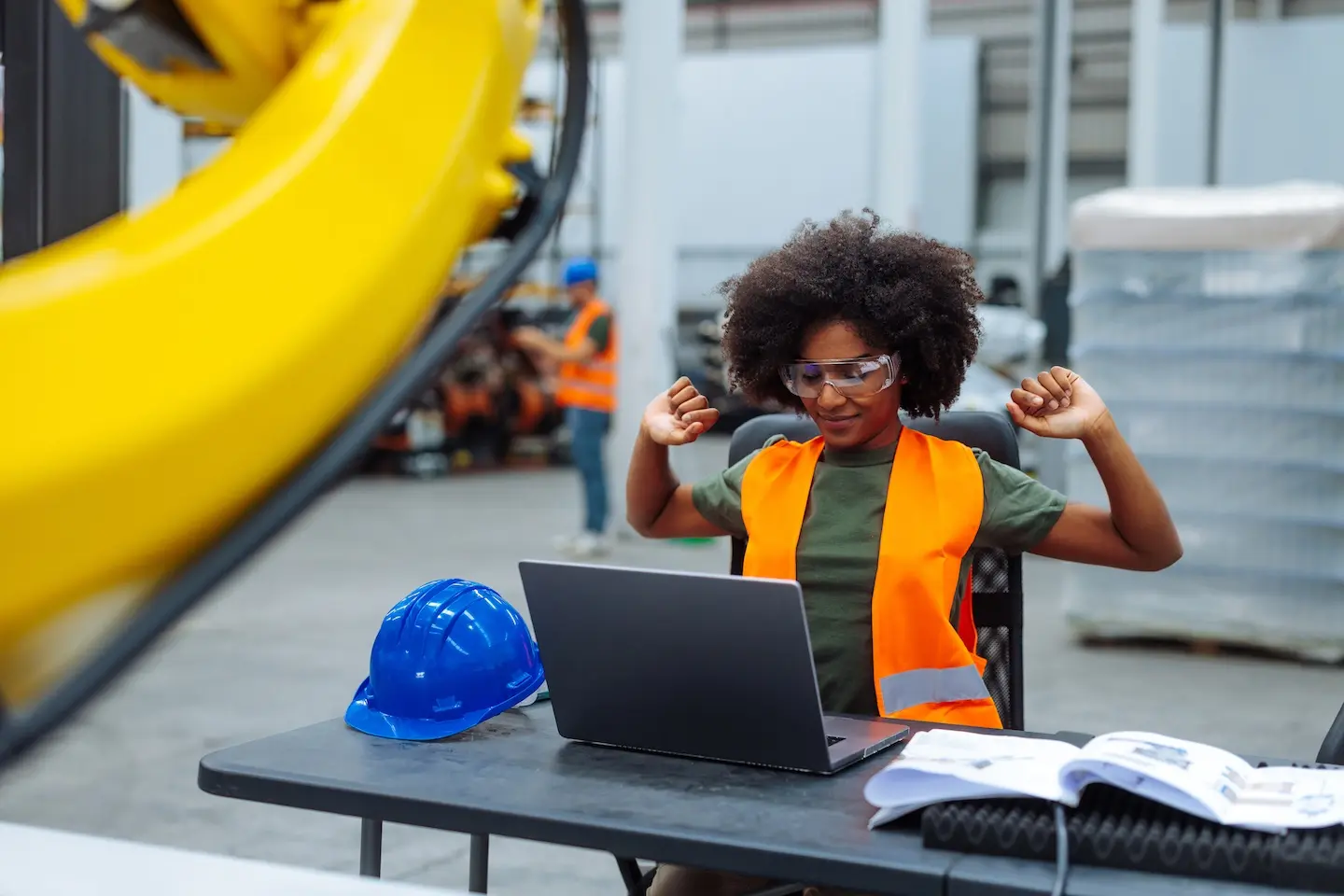 Women stretching at work in a high-vis jacket